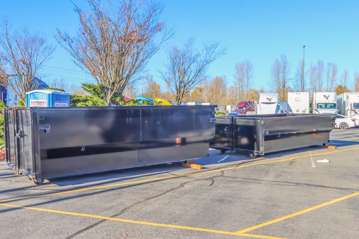Professional dumpster rental service with roll-off container on residential driveway in North Branford